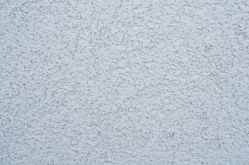 horizontal background of a wall with applied decorative gray uneven rough plaster