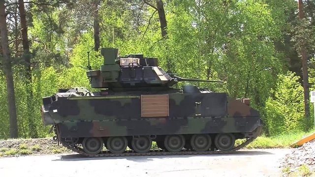 Bradley fighting vehicle firing machine gun