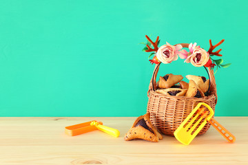 Purim celebration concept (jewish carnival holiday) with traditional hamantasch cookies and deer...
