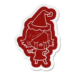 cartoon  sticker of a girl crying and pointing wearing santa hat