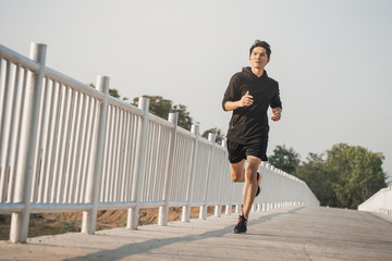 Young man running in the nature. Healthy lifestyle and sport concepts.  Runner training in a urban...