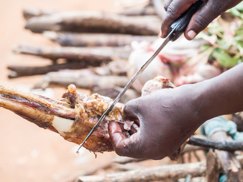 Nyama choma, grilled meat prepared in traditional way over fire on a Maasai market in Tanzania, Africa.