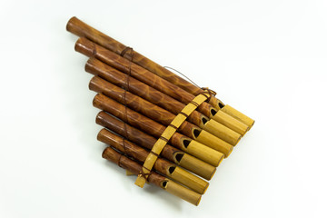 Pan flute instrument on white background.