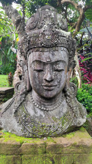 Fototapeta na wymiar Buddha image in the tropical garden in Bali