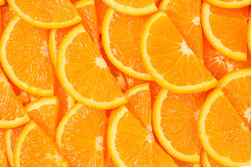Slices of oranges as a background, top view.