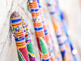 Maasai rungu (club) decorated with beads and sold as a souvenir at a local Maasai Market. Close up.