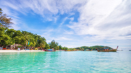 Panorama of Koh Lipe Sunset Beach with water on foreground