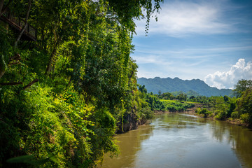 Obraz premium Blue sky high peak mountains fog hills mist scenery river lake dam bay gulf wildlife National park views Kanchanaburi, Thailand.
