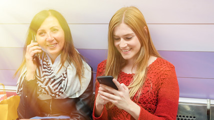 Couple of female friends talking in the subway station