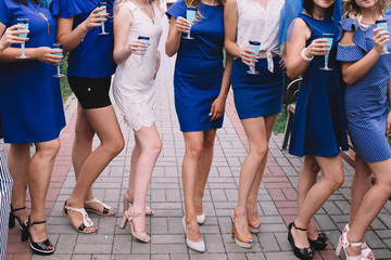 Bachelorette party, girls in blue dresses with glasses of champagne are having fun