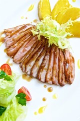 duck slices with pear slices and salad