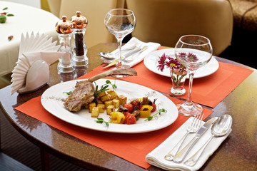 lamb leg with baked potatoes and herbs