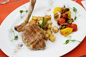 lamb leg with baked potatoes and herbs