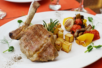 lamb leg with baked potatoes and herbs