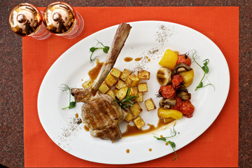 lamb leg with baked potatoes and herbs