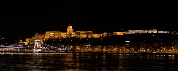 Foto op Plexiglas Panoramic landscape of Budapest with the Chain Bridge, Buda Castle, Presidental Palace and the Carmelite Monastery by night © Dronandy