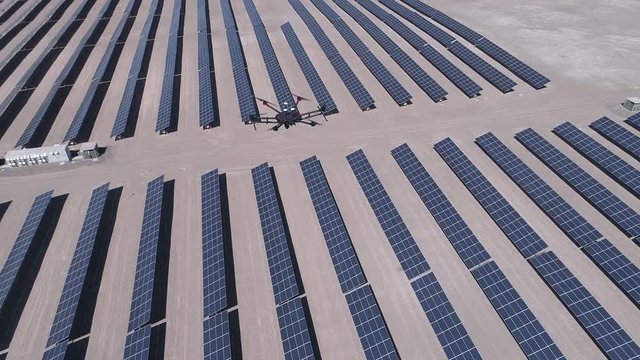 UAV Drone survey, flying and working for ortophoto and thermal analysis of PV Plants with visual and thermal camera. Aerial footage from other drone to the drone working in the solar energy plant
