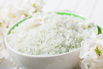 cosmetic creams and white lilac blossom on bright wooden table background