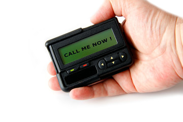 pager or beeper with the words "call me now" on the screen, isolated on white background