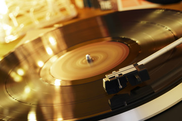 Turntable player with background of a stack of audition records and a Christmas tree. Sound...