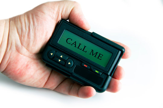 old device pager / beeper with sign "call me" in hand