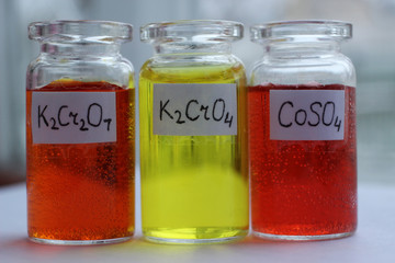 Analytical chemistry reagents: orange potassium dichromate, yellow potassium chromate, red cobalt...