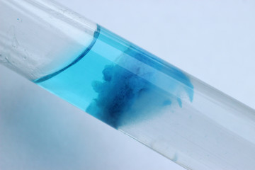 Chemical reaction of the formation of a blue precipitate of copper silicate.