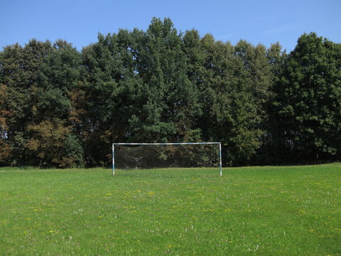 Landscape of nature in the summer with an old football goal on the meadow