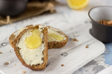 Pieces of bread with butter and honey
