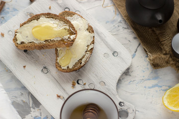 Pieces of bread with butter and honey
