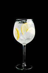 Gin based cocktail in wine glass isolated on black background. Selective focus. Shallow depth of field.