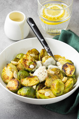 Roasted Brussels sprouts with peanuts and white sauce, delicious vegetarian lunch. Healthy, organic food, vegetable garnish