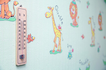 Wall thermometer on a frosty window. Meteorology thermometer isolated on white background. Thermometer shows air temperature plus 50 degrees celsius .