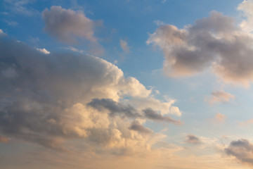Fototapeta na wymiar Beautiful cumulus clouds of unusual shape in the blue sky on a summer day