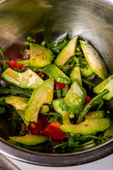 quinoa salad with tomato, cucumber and avocado jn a wh