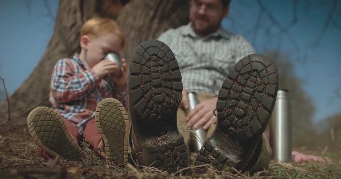Father and Son picnic under tree