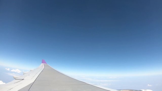Timel apse Footage of Airplane Wing Against the Blue Sky
