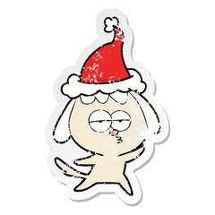 distressed sticker cartoon of a bored dog wearing santa hat