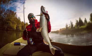 Fishing. Fisherman and trophy Pike.