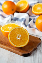 Obraz na płótnie Canvas Halved and whole oranges, side view. Closeup. Selective focus.