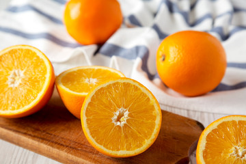 Obraz na płótnie Canvas Halved and whole oranges, side view. Close-up. Selective focus.