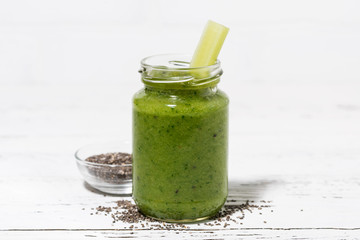healthy green fruit and vegetable smoothies with chia seeds in jar on white table