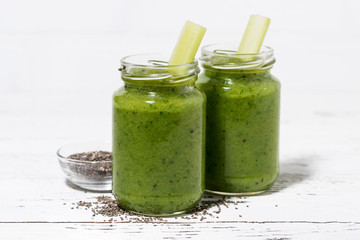 healthy green fruit and vegetable smoothies with chia seeds in jars, closeup