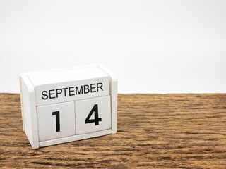 September 14 white cube wooden calendar on vintage wood and white background with autumn day,...
