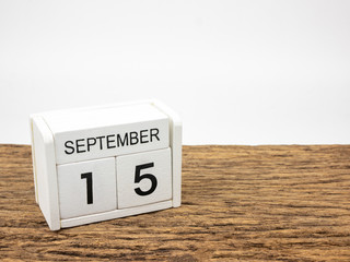 September 15 white cube wooden calendar on vintage wood and white background with autumn day,...