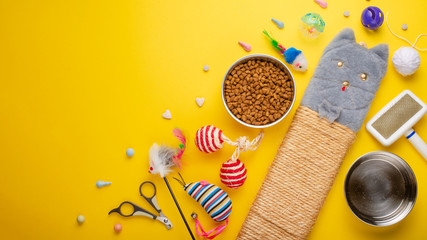 Pet, cat, food and accessories of cat living flat lay, with space for design, on a yellow...
