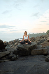Naklejka na ściany i meble Woman Practicing Yoga in the Nature. Meditating Outdoors