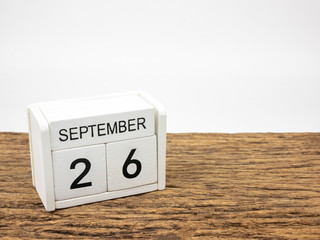 September 26 white cube wooden calendar on vintage wood and white background with autumn day, Copyspace for text