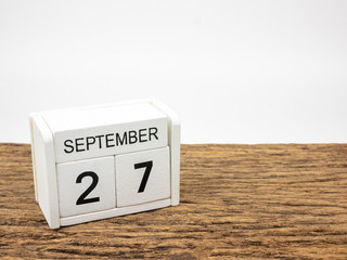 September 27 white cube wooden calendar on vintage wood and white background with autumn day, Copyspace for text