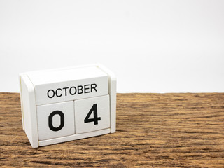 October 4 white cube wooden calendar on vintage wood and white background with autumn day, Copyspace for text